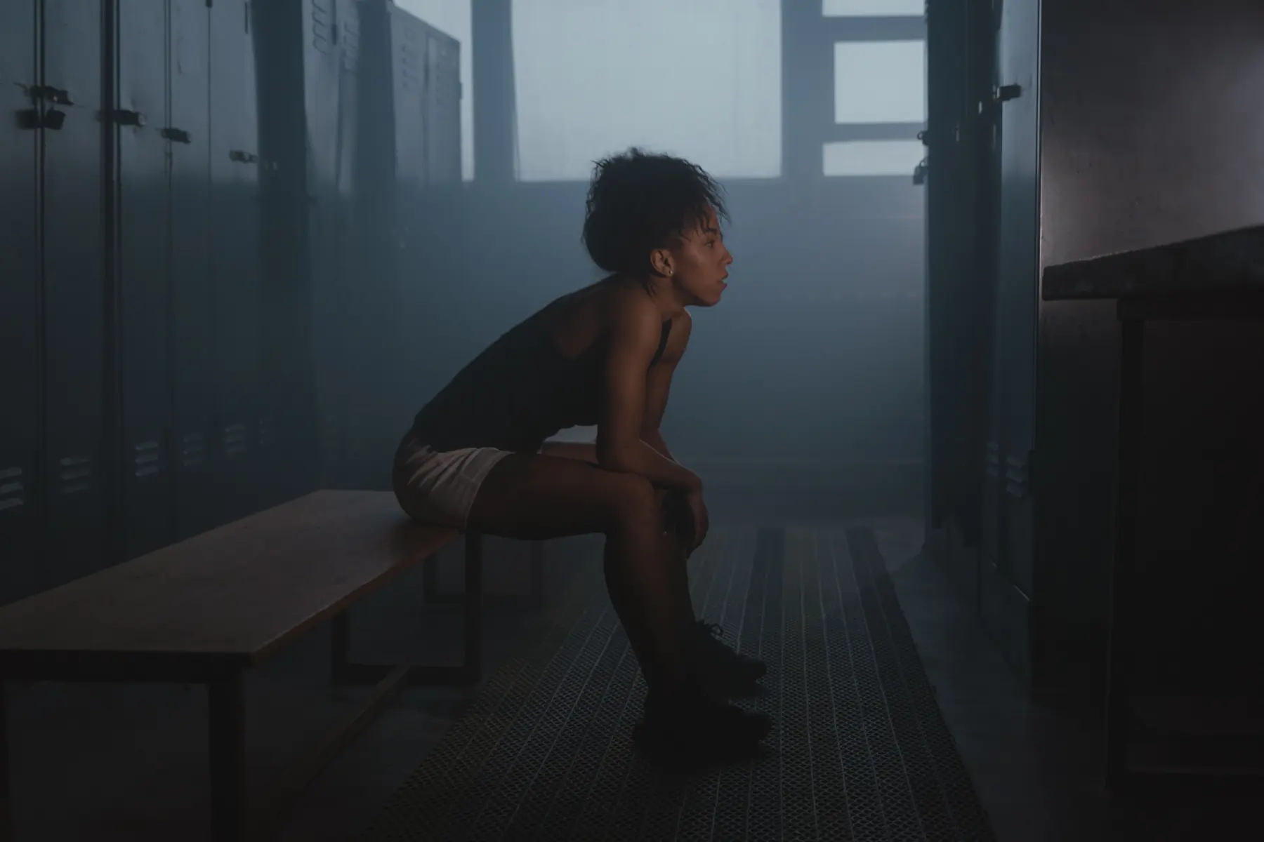 An athlete rests on the changing-room bench